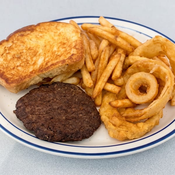 A plate with a hamburger patty, grilled toast, french fries, and onion rings.